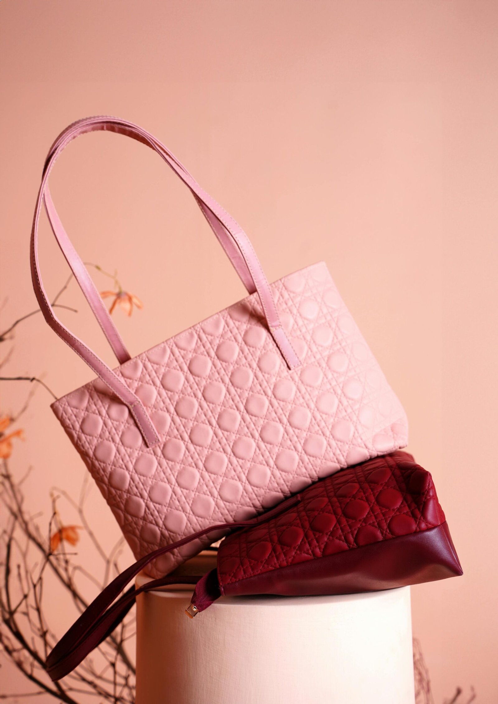 Elegant pink and red quilted handbags showcased in a studio setting.